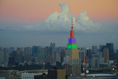 Modern buildings in city against cloudy sky