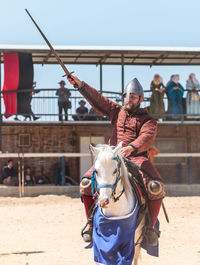 Men in traditional clothing against sky