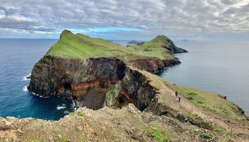 Scenic view of rock formation in sea against sky