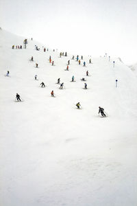 High angle view of people on snow covered landscape