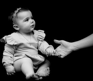 Cute baby boy against black background