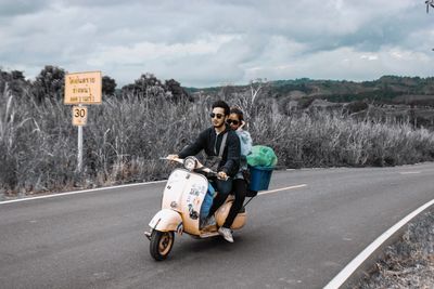 Woman riding motorcycle on road