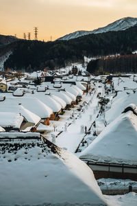 Snow covered buildings against sky