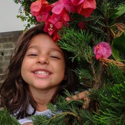 Portrait of smiling girl with flower plants