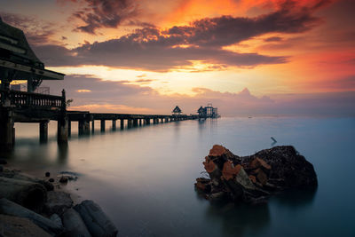 Scenic view of sea against orange sky