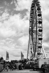 Low angle view of ferris wheel in city against sky