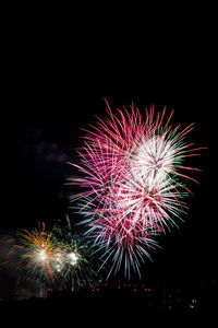 Low angle view of firework display at night