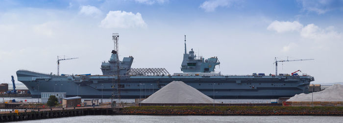 Commercial dock against buildings in city against sky