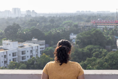 Rear view of woman looking at foliage 