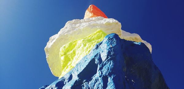Low angle view of ice cream against blue sky