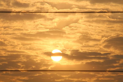 Low angle view of sun in sky during sunset