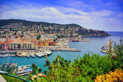 High angle view of townscape by sea against sky