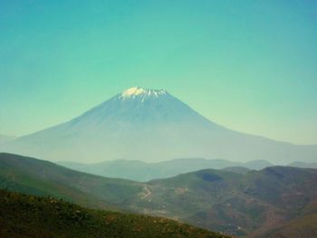 View of volcanic mountain against blue sky