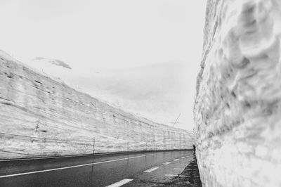 Road by sea against clear sky