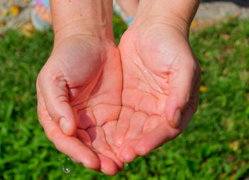 Low section of person on wet hand
