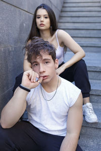 Portrait of a smiling young woman sitting outdoors