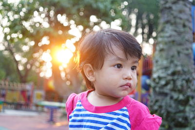 Portrait of cute girl looking away outdoors