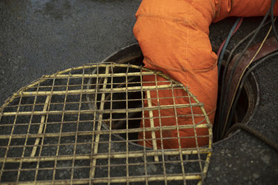 Orange pipe descends into hatch. sewer repair. wastewater pumping. air supply. sewer repair.