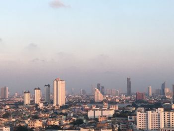 Modern buildings in city against river view