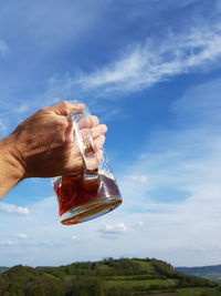 Close-up of hand holding beer glass