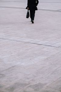 Low section of man walking on floor