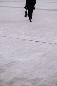 Low section of man walking on street