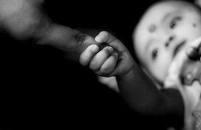 Close-up of baby holding finger