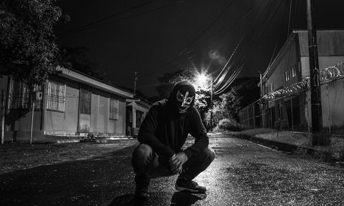 Man with dog on road at night