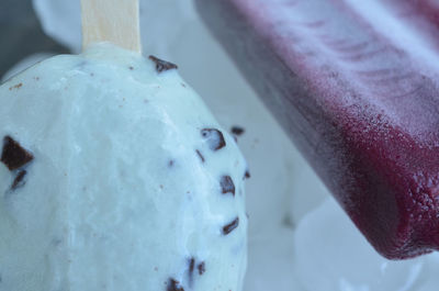 Mint chocolate chip frozen yogurt on a stick and grape frozen popsicle