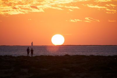 Scenic view of sea against orange sky