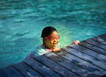 Portrait of boy swimming in pool