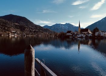 Scenic view of lake by mountains against sky