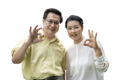 Portrait of friends standing against white background