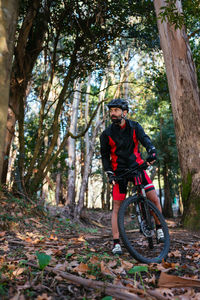 Man riding bicycle in forest