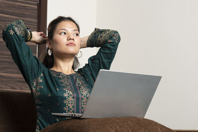 Portrait of young woman looking at camera