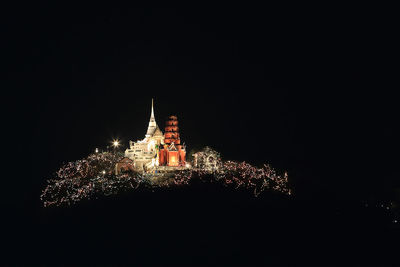 Low angle view of illuminated tower at night