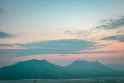 Scenic view of mountains against sky at sunset