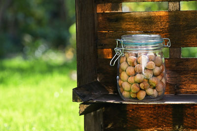 Close-up of fruits in jar on wooden table