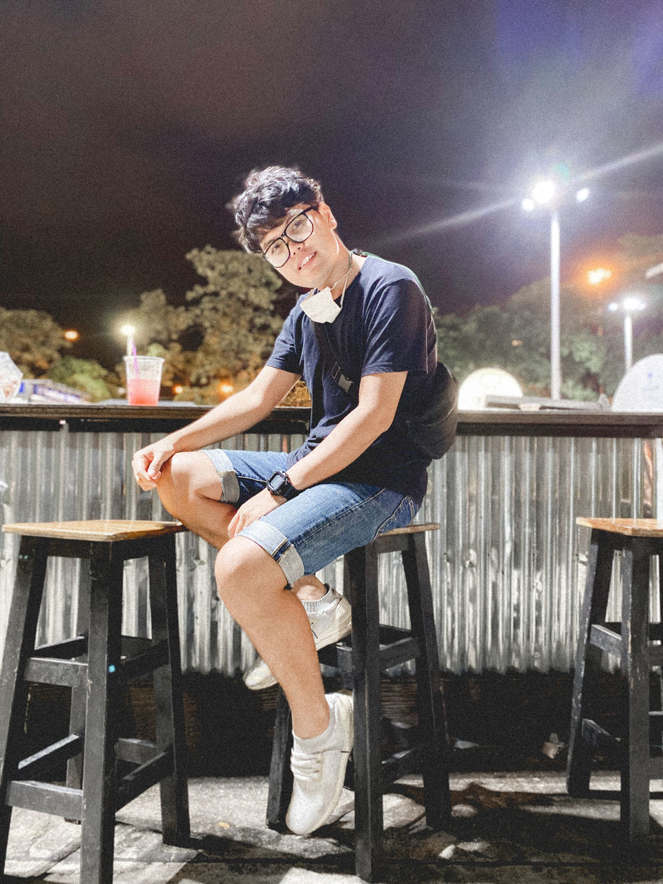 FULL LENGTH OF YOUNG MAN SITTING ON TABLE