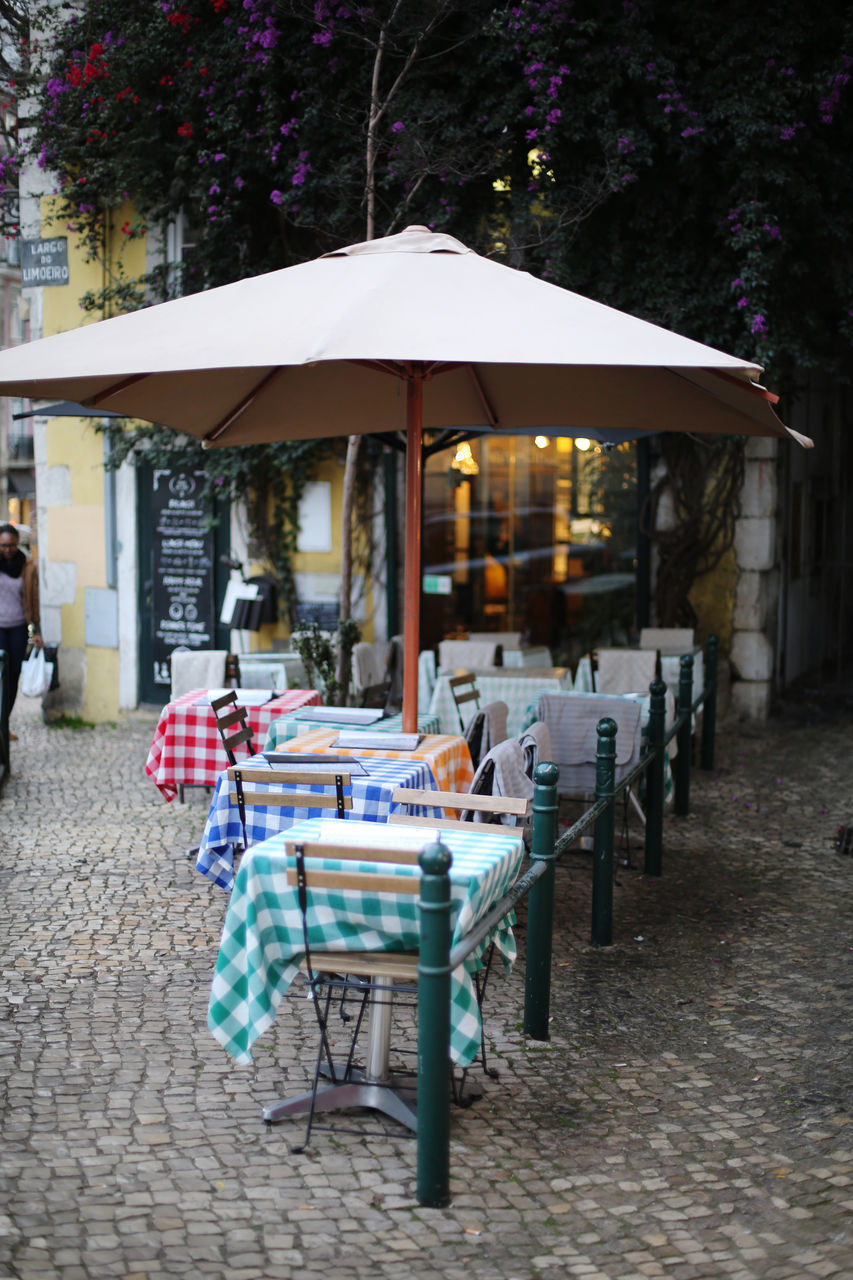 CHAIRS AND TABLES AT SIDEWALK CAFE