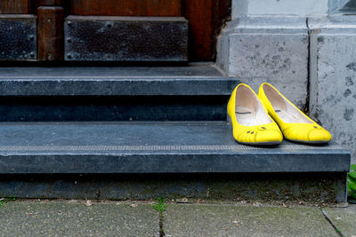 Close-up of yellow shoes on steps