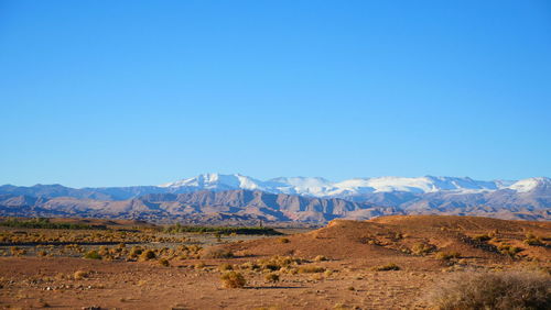 Scenic view of mountains against clear blue sky