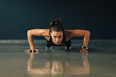 Portrait of woman exercising on floor