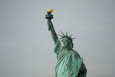 Low angle view of statue against sky