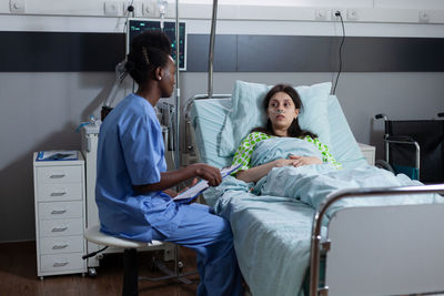 Nurse examining patient in hospital