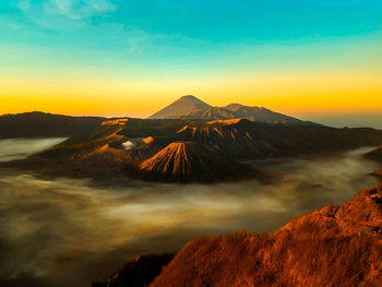 Scenic view of mountain range against sky during sunset