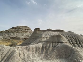 Rock formations on landscape against sky