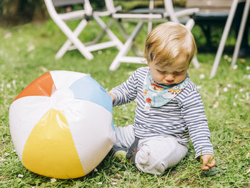 Cute boy sitting on grass
