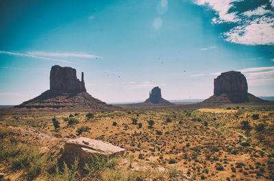 Scenic view of rock formations on landscape against sky