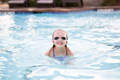 Portrait of woman swimming in pool